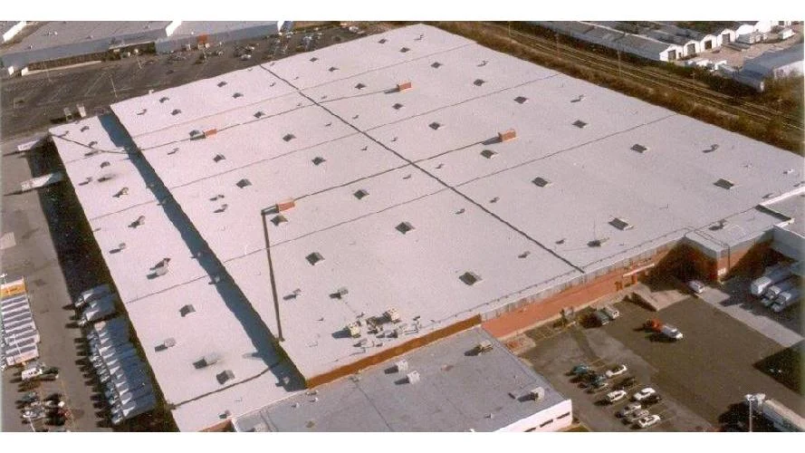 Flat roof drainage system installation on commercial building in Amity Harbor NY by All-Star Roofing Inc.