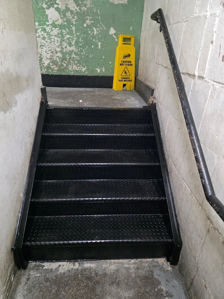 Steel fabricator in Brooklyn, NY — custom steel mezzanine and staircase transforming a commercial warehouse space